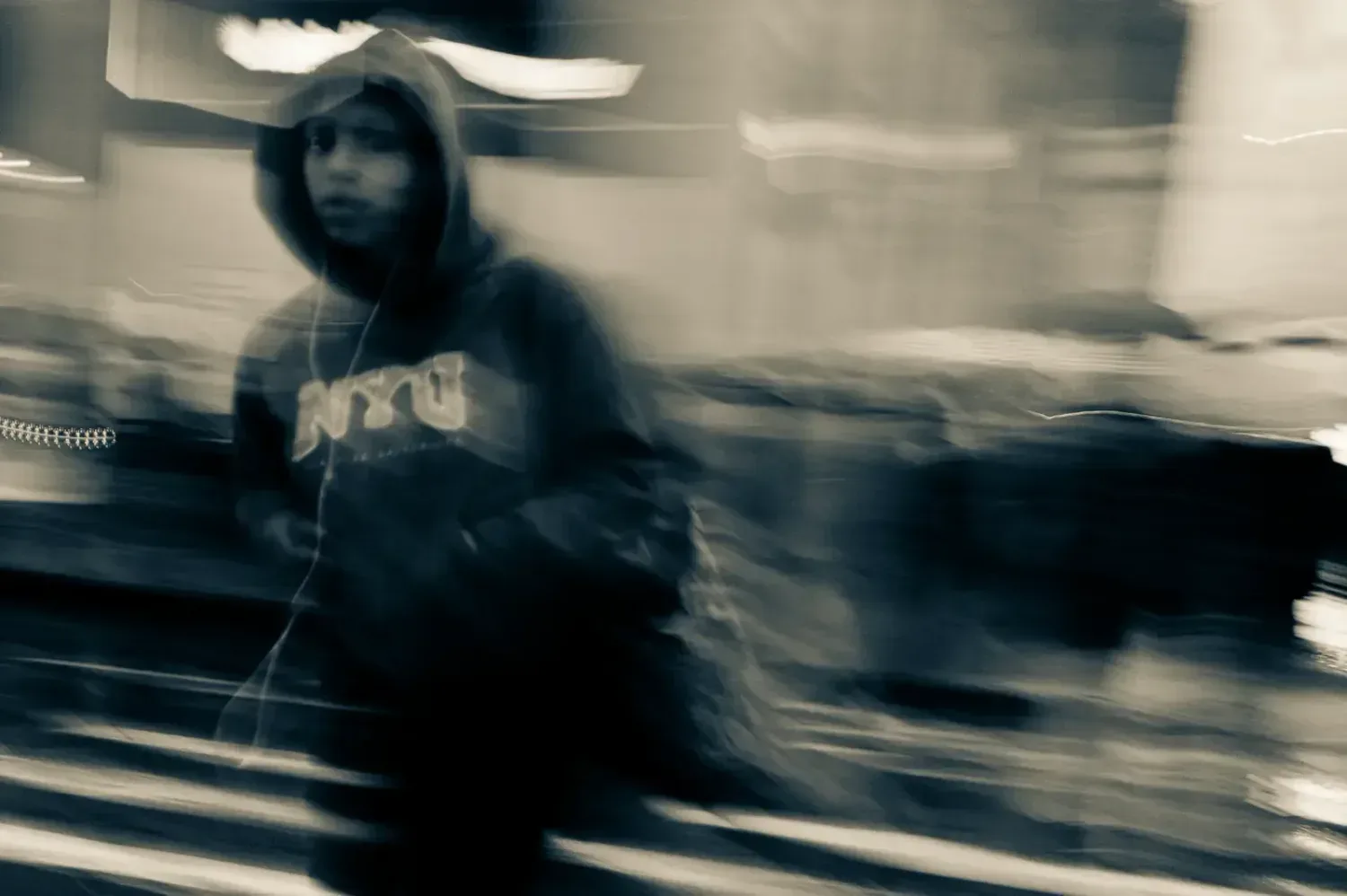 A girl in a hoodie crossing 42nd, Metamorphosis, The New York Trilogy